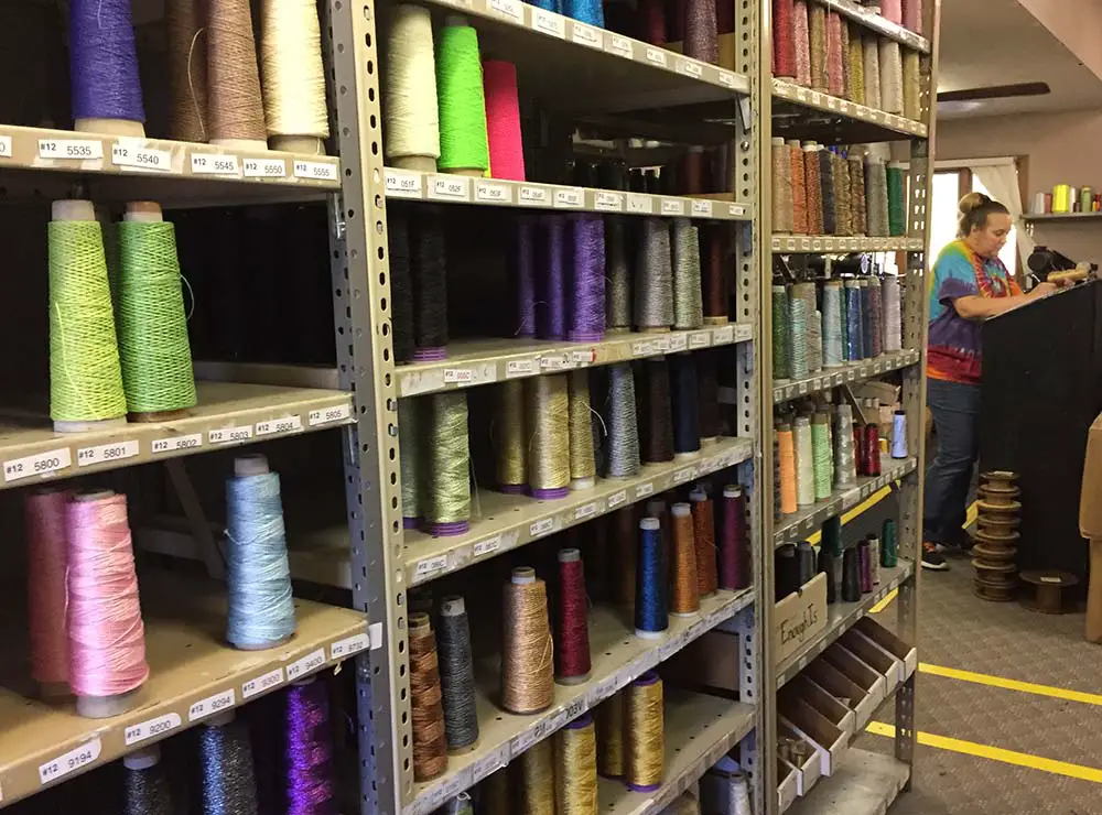 The factory is divided into the silk thread section, and the metallic thread section (shown here). Threads are made, coned, spools, labeled, and packaged in a gigantic room of color and music (could not help but tap my foot to some good classic rock playing in the room).