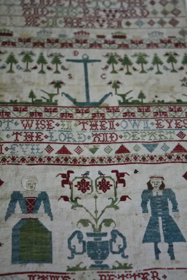 Textile Folk Art by Anne Kelly, image of a sampler from history.
