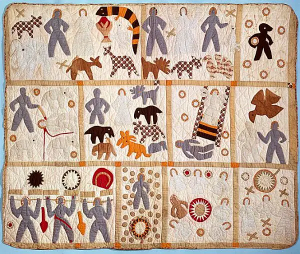 A folk art pictorial quilt in muted colours on the bible theme.