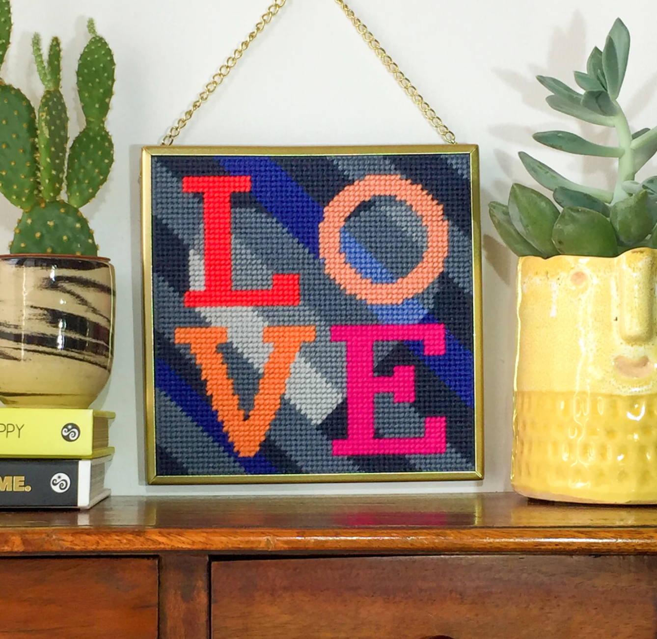 Needlepoint kit designed by Hannah Bass showing the word Love.