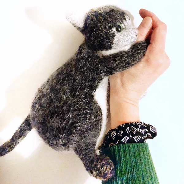 Claire Garland the artist has knitted a cat in grey and white.