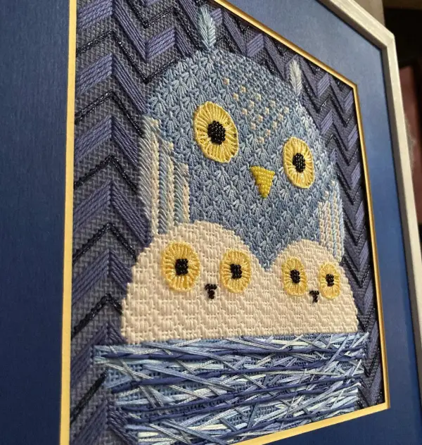 An owl needlepoint piece by The Marquis Sisters