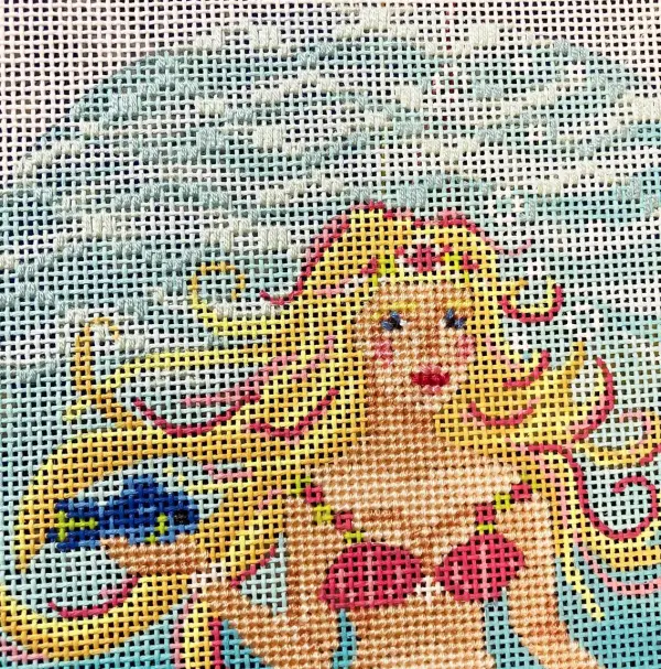 A mermaid needlepoint piece by The Marquis Sisters