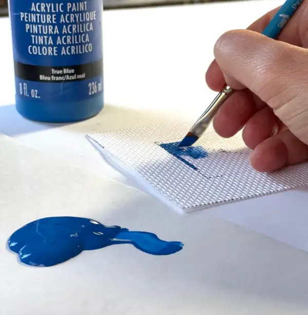 Jenny Henry paints on to needlepoint canvas